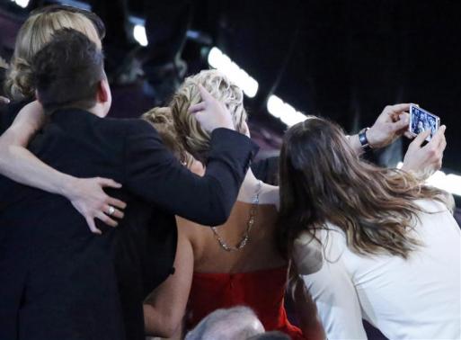 Host Degeneres takes a group picture at the 86th Academy Awards in Hollywood